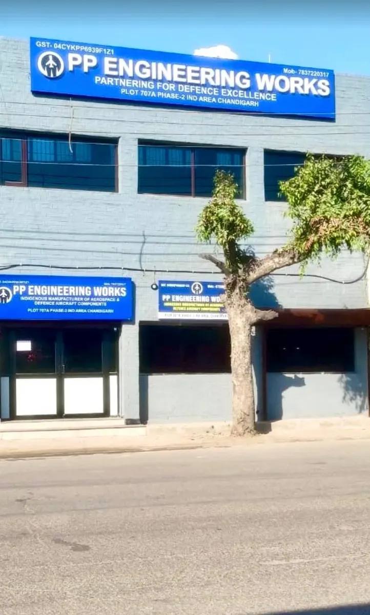 Two-storey works building with PP Engineering Works signage above the first floor, seen from the street.